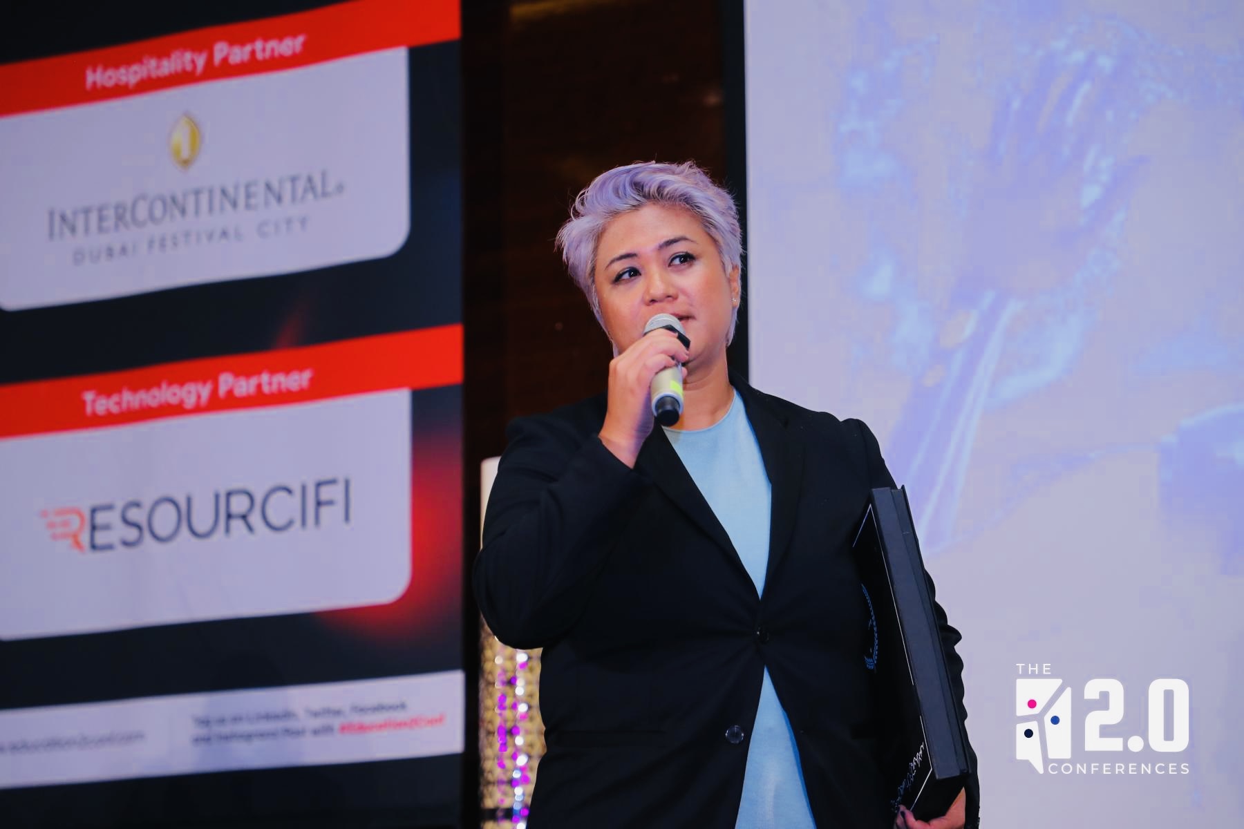 Dr. Kayden Perera speaking at an event
