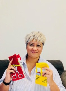 Kayden Perera holding red and yellow socks